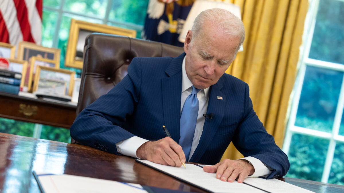 Joe Biden signing something