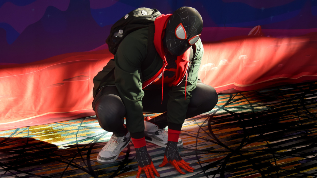 Spider-Man in Miles Morales suit strikes classic Spider-Man pose.