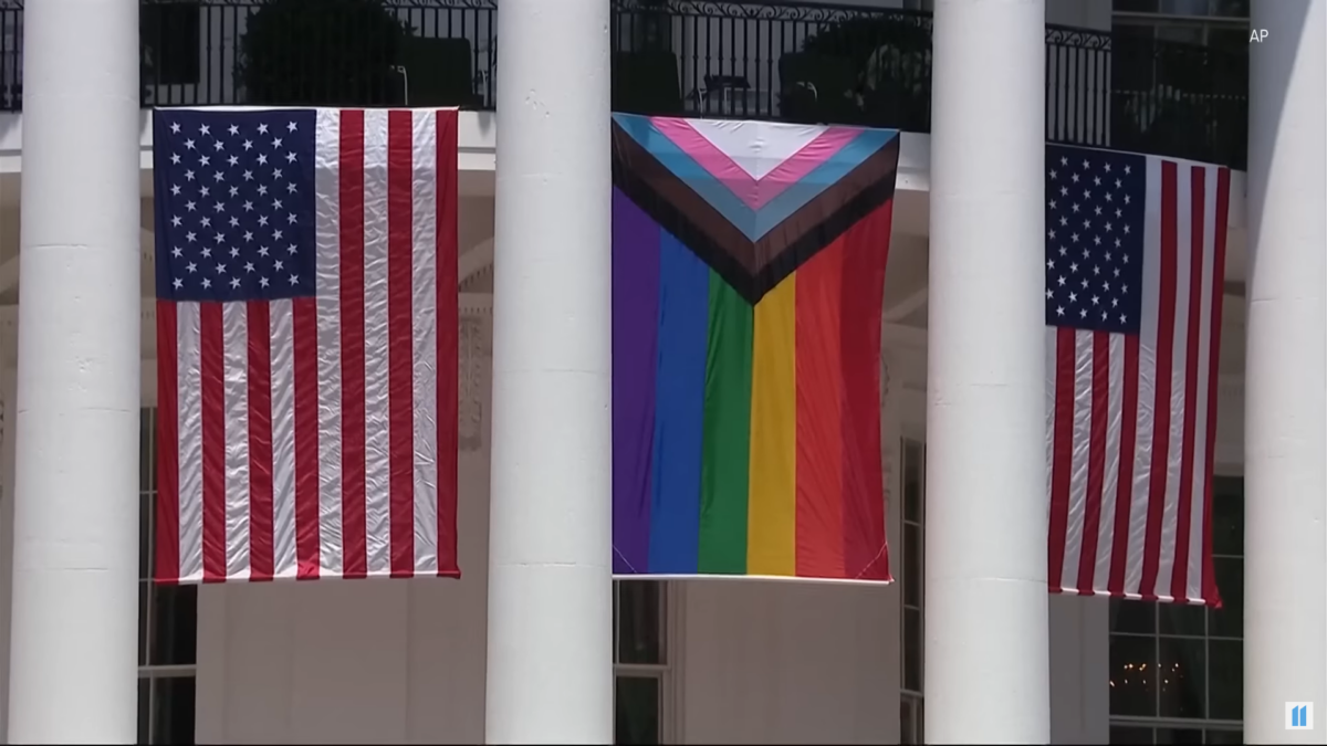 Pride flag flanked by American flag