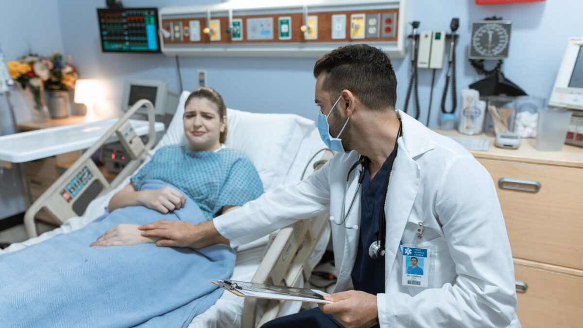Doctor consoles crying female patient