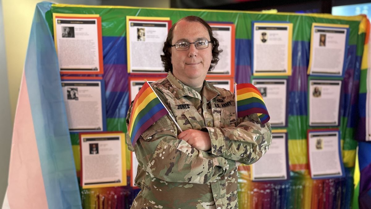 Maj. Rachel Jones posing with pride flags