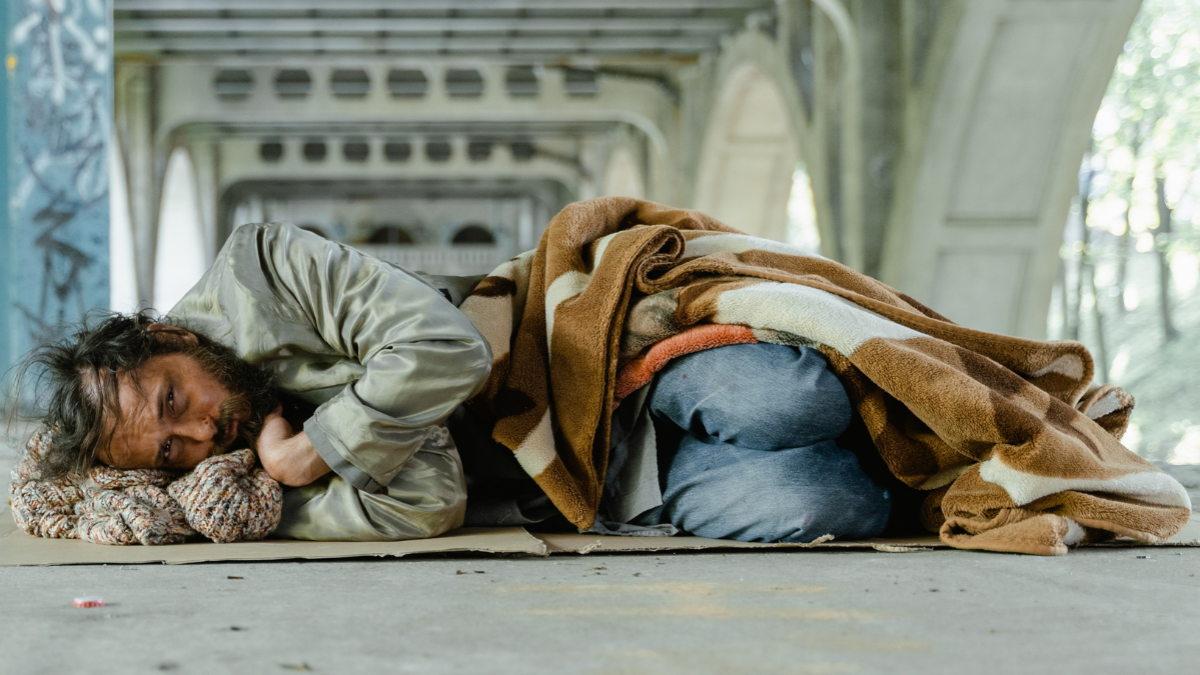 Homeless man laying on ground
