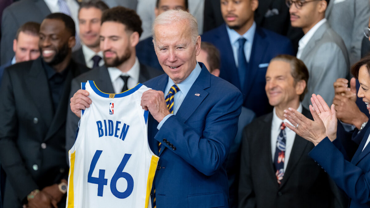 Joe Biden holding basketball jersey