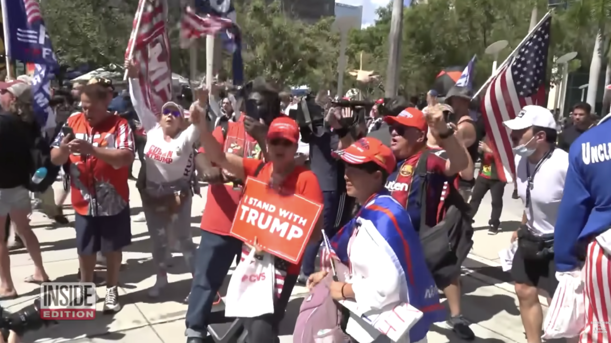 trump supporters with flags and hats protesting