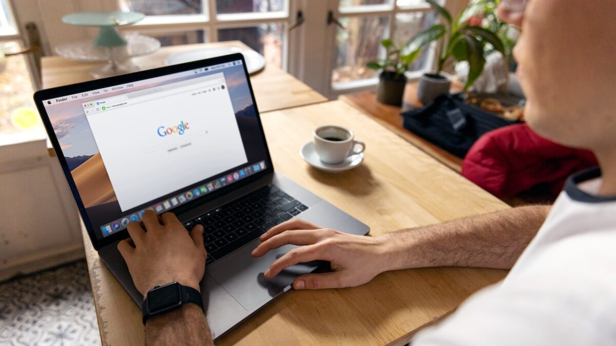 man using Google on a laptop