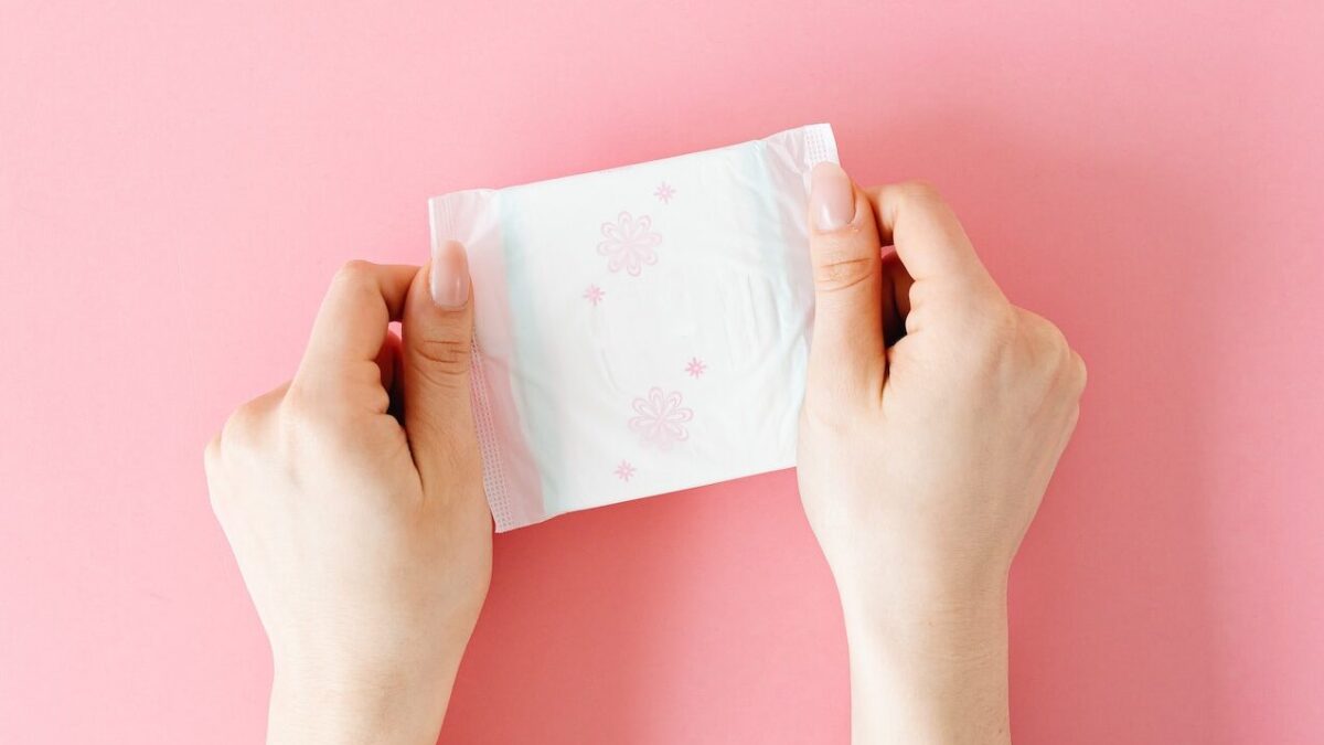 woman holding a menstrual pad