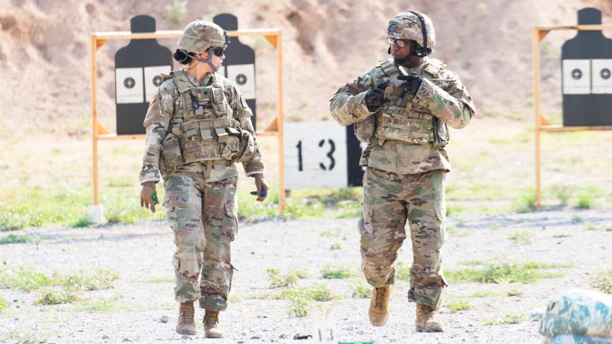 man and woman in camouflage at a shooting range