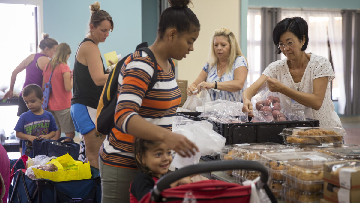 Volunteers with the Saddleback Church help families pick out groceries during a food pantry event at the Blinder Memorial Chapel at Marine Corps Base Camp Pendleton, California, Sept. 5, 2018. All the food handed out was donated by the church and was given out to service members and families. (U.S. Marine Corps photo by lance Cpl. Betzabeth Y. Galvan)