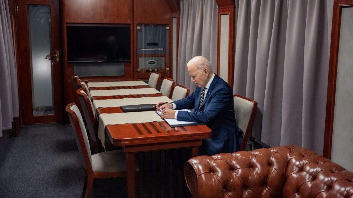 Joe Biden sits at table