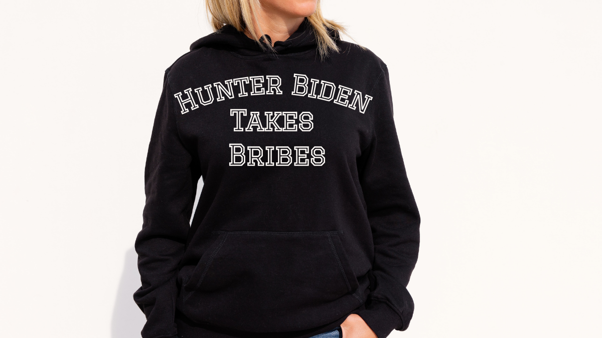 Woman wearing hoodie that says "Hunter Biden takes bribes"