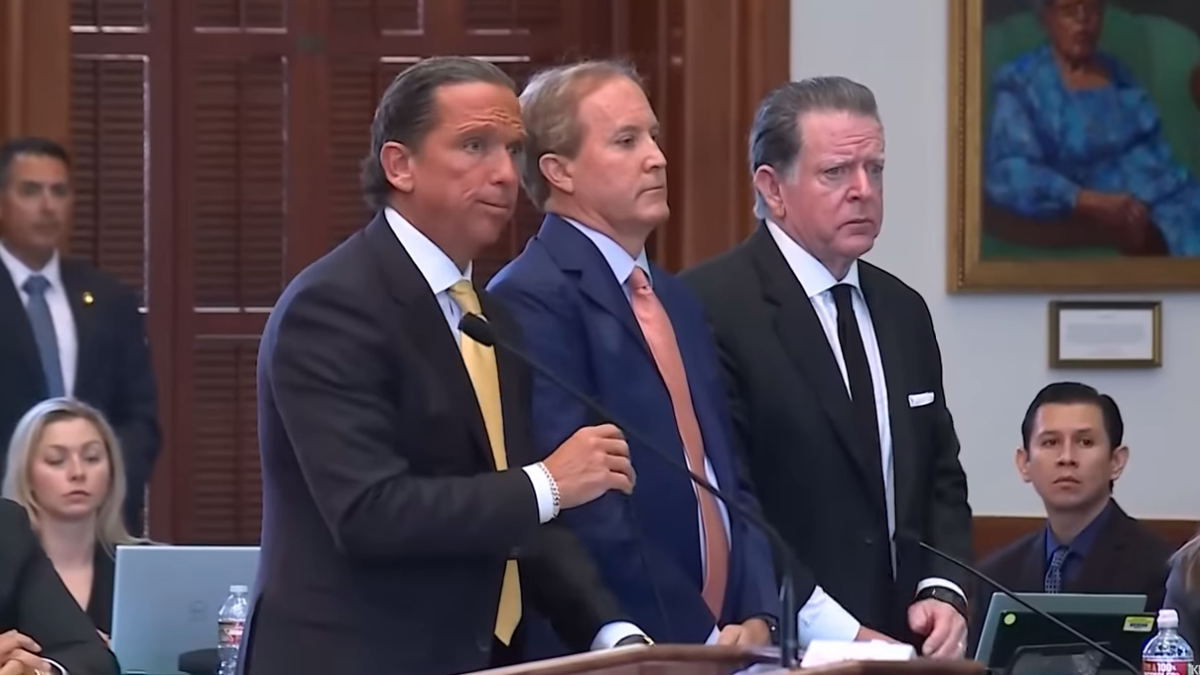 Ken Paxton standing with lawyers in Senate chamber