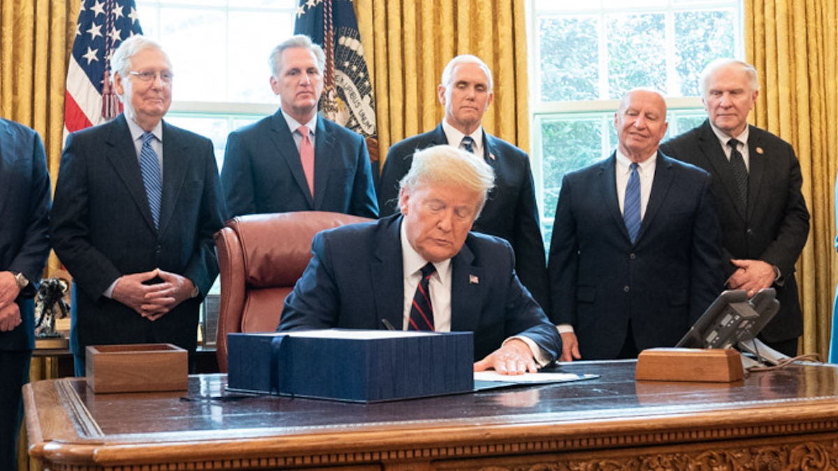 Donald Trump signs legislation surrounded by McConnell, McCarthy, Pence, and others