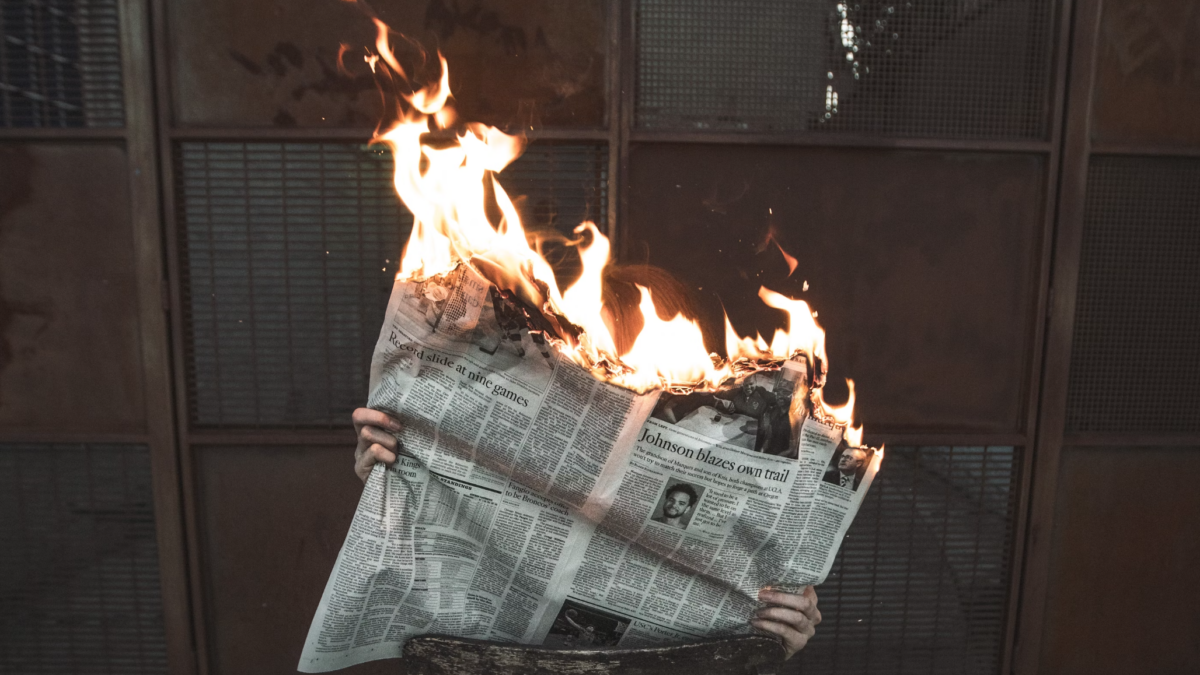 newspaper on fire