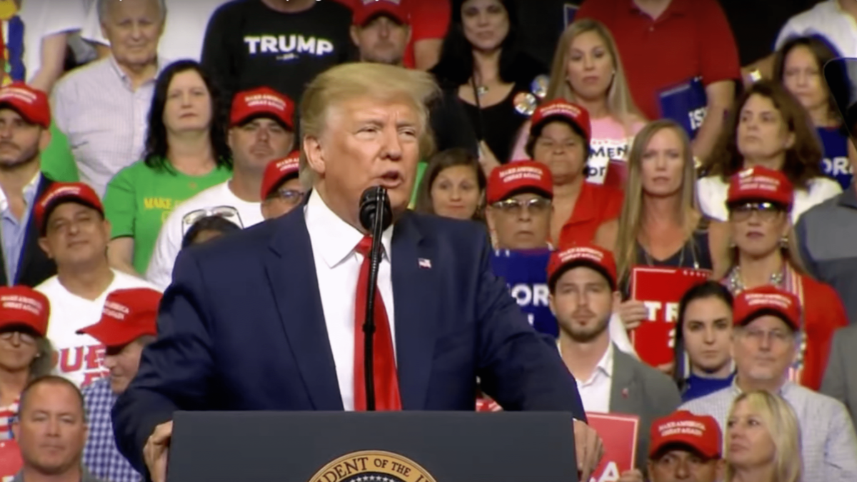 President Donald Trump surrounded by supporters at a rally