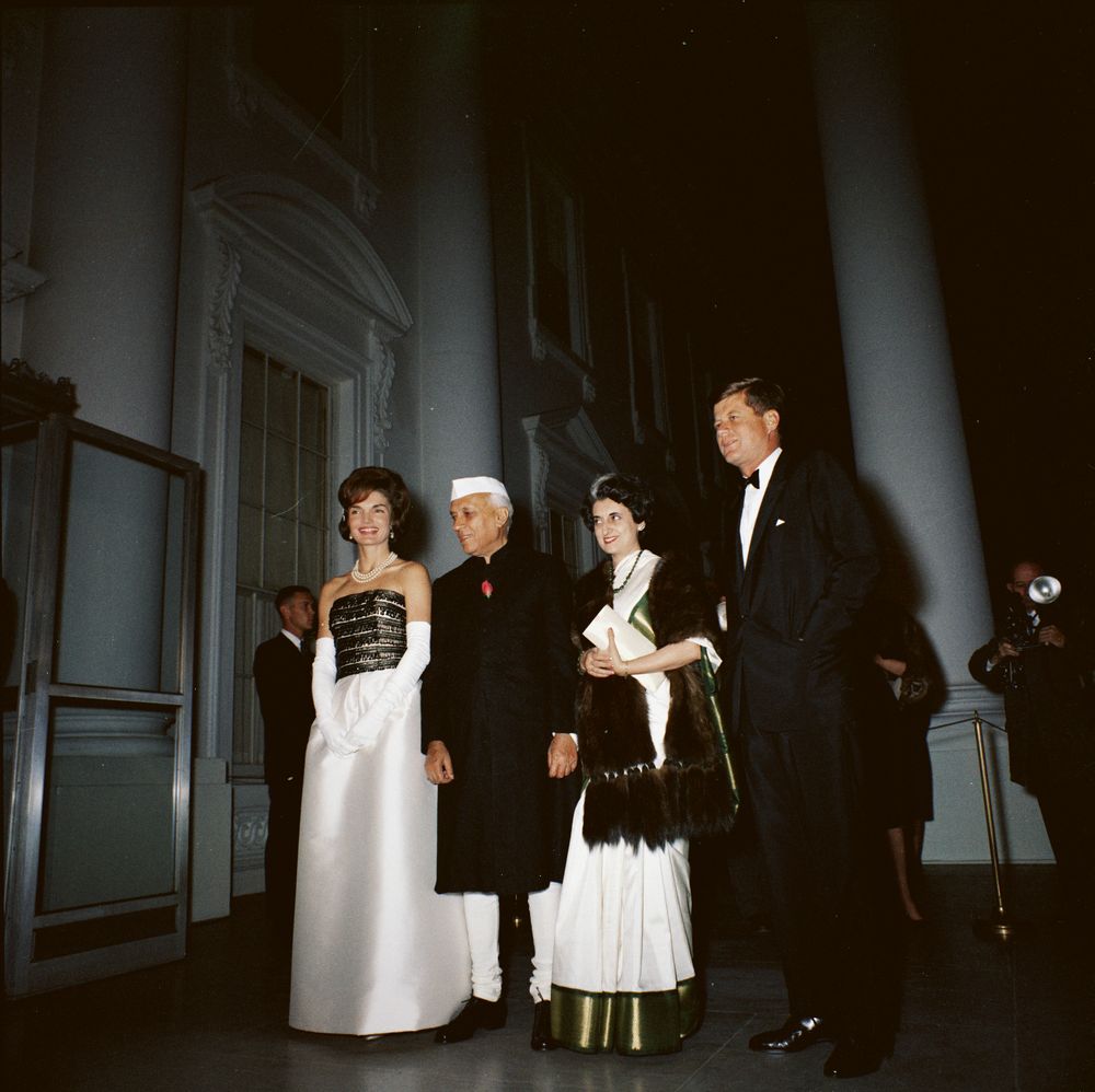 At a dinner in honor of Prime Minister Jawaharlal Nehru of India, President John F. Kennedy and guests pose in the North Portico, White House, Washington, D.C. (L-R) First Lady Jacqueline Kennedy; Prime Minister Nehru; the Prime Ministerâ€™s daughter Indira Ghandi; President Kennedy.