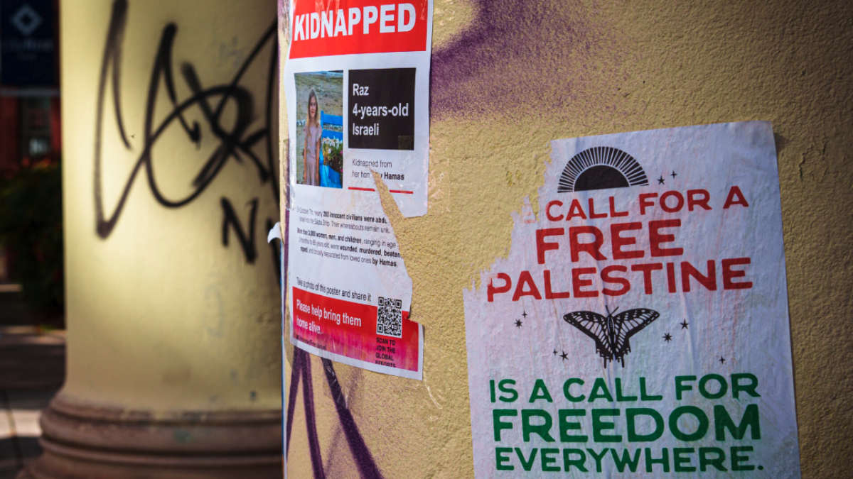 Hostage poster and free palestine poster next to each other on collumn
