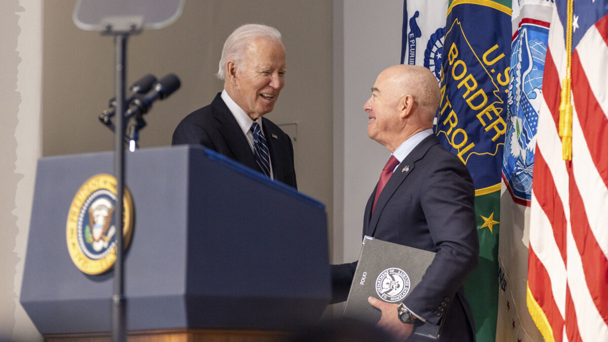 Joe Biden shakes hands with Alejandro Mayorkas