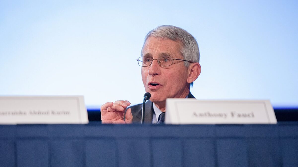 Dr. Fauci speaking behind table
