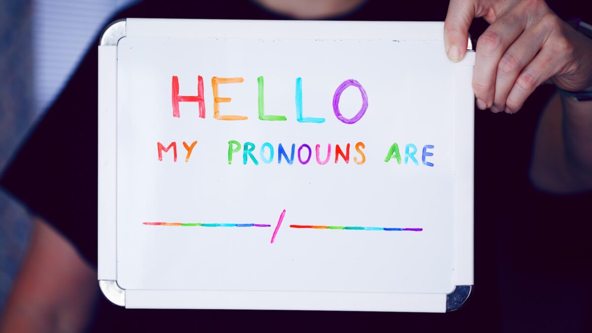 hello my pronouns are written in rainbow marker on a white board