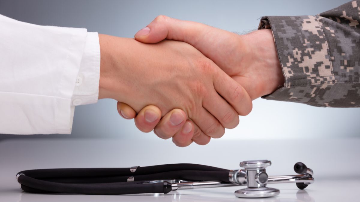 medical professional and soldier shaking hands