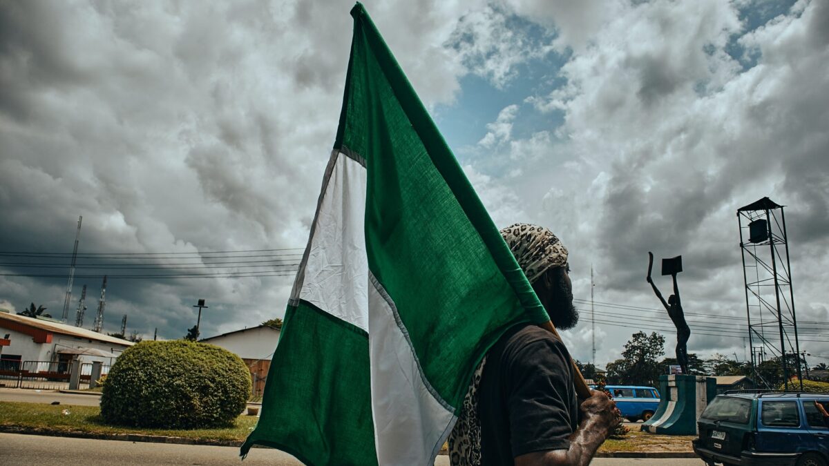 Man holding Nigerian flag.