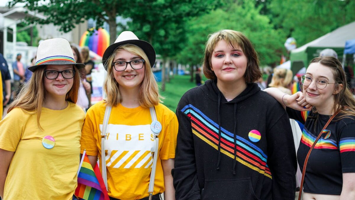 four girls pose for photo at pride parade