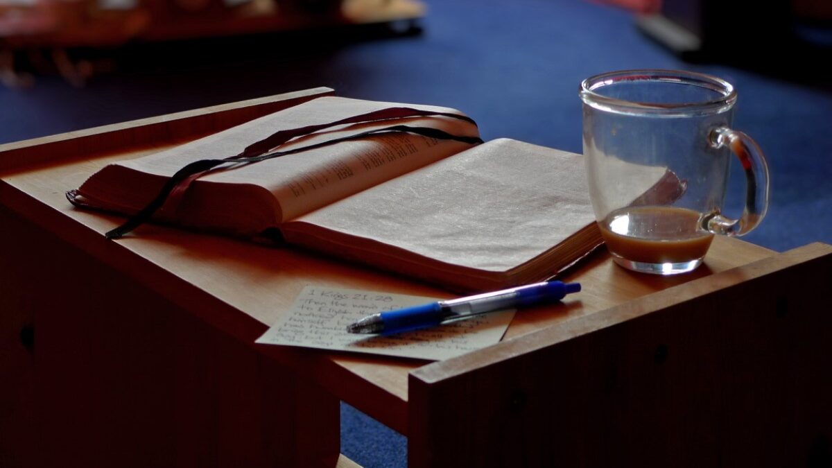 open bible next to coffee cup