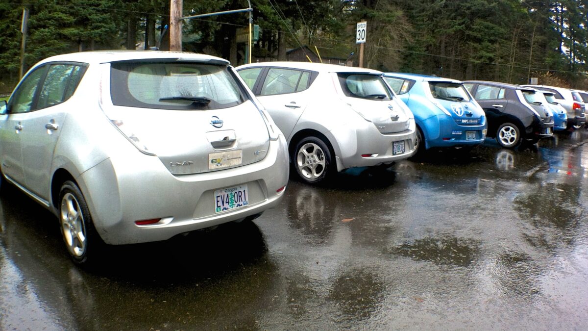 Electric vehicles parked in the rain