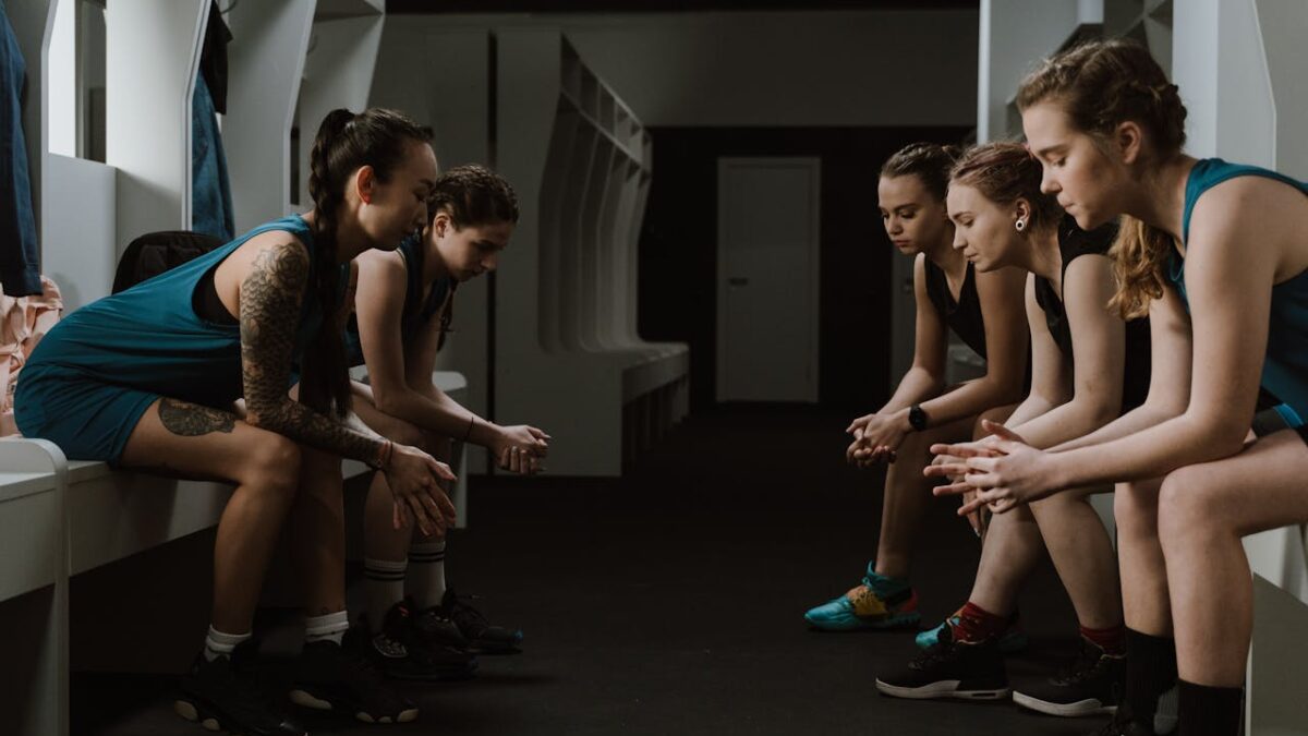 women sitting together in a locker room