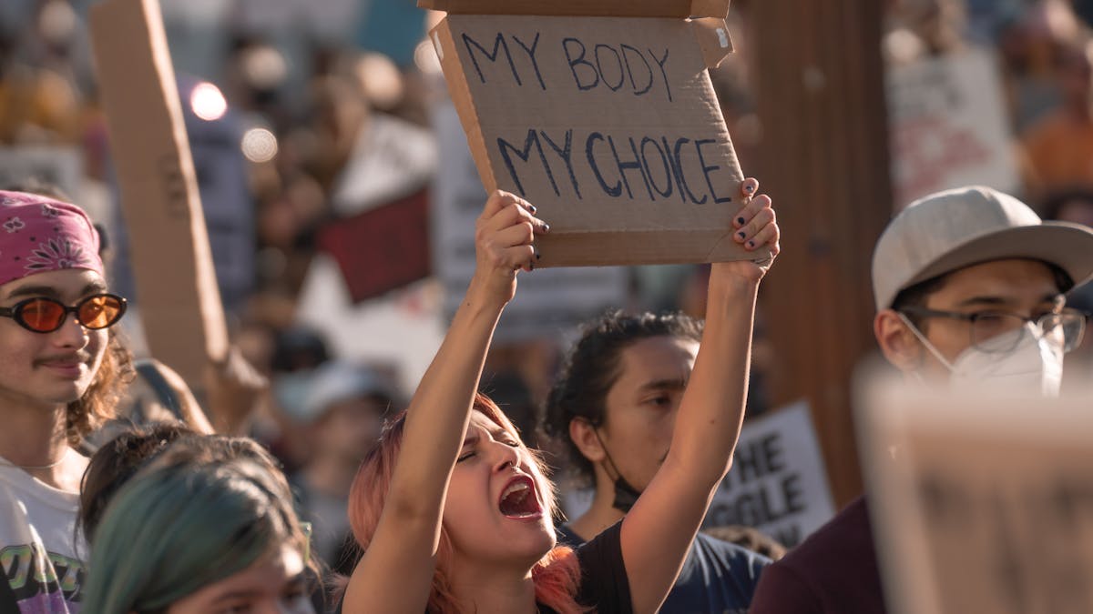 woman holding ‘my body, my choice’ sign