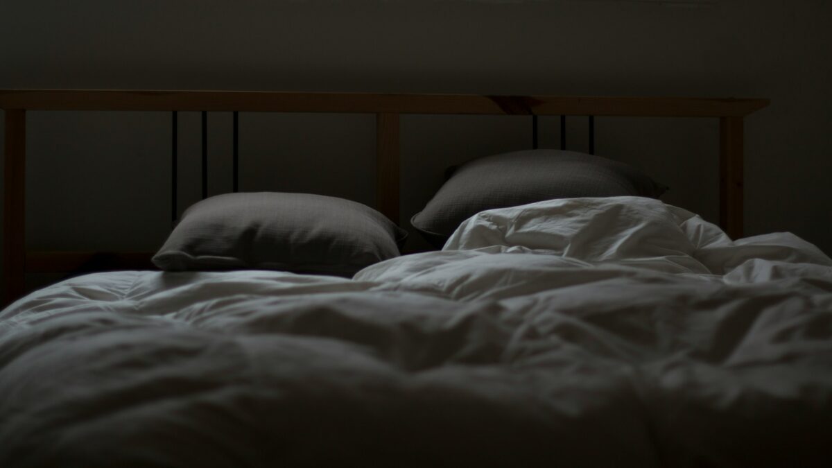Empty bed in a dark room