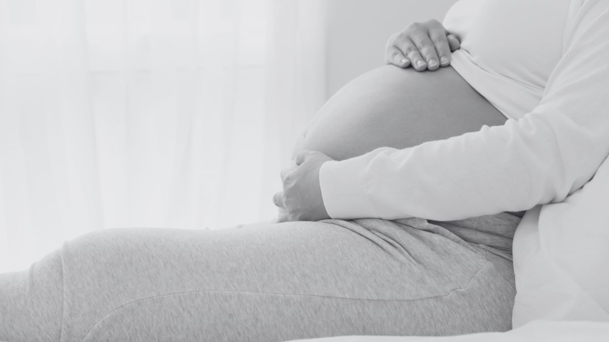 pregnant woman holding her belly black and white