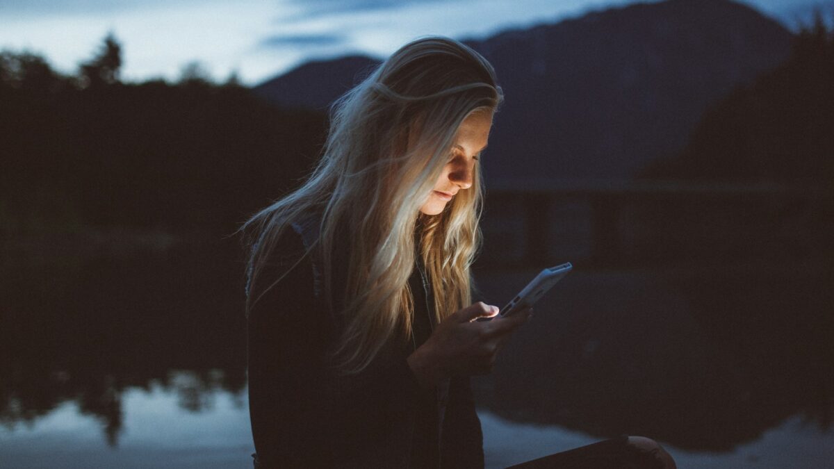 Woman scrolling on her phone outdoors