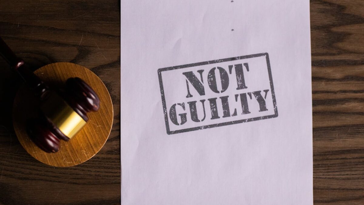 'Not Guilty' sign next to gavel