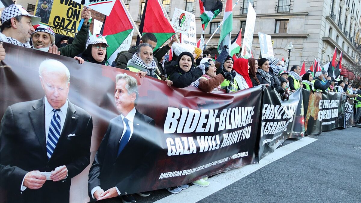 pro-hamas protestors carrying sign with biden and blinken photos on it