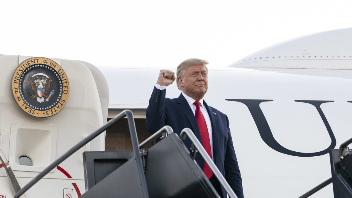 Trump makes a fist while boarding air force one