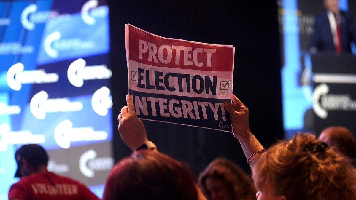 Someone holding an 'election integrity' sign.