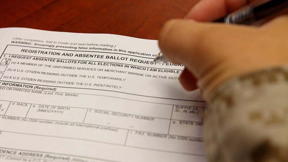 Service member filling out absentee ballot.
