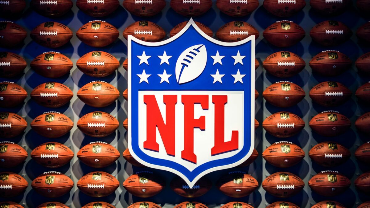 NFL logo in front of footballs