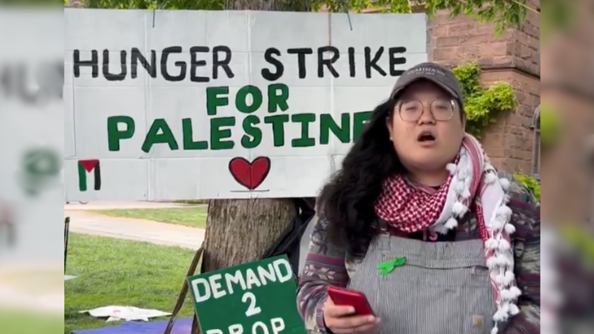 protester in front of hunger strike sign
