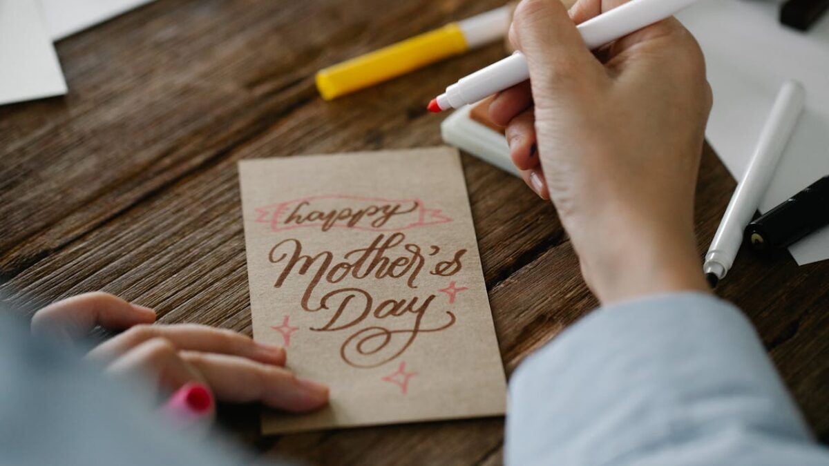 person writing mother's day card