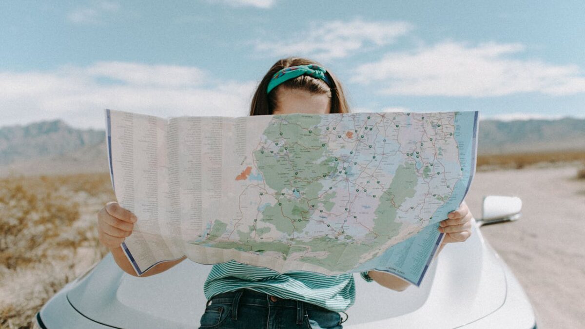 woman looking at map on road trip