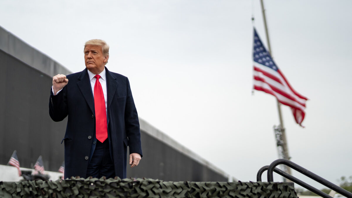 Trump pumps his fist in front of border wall