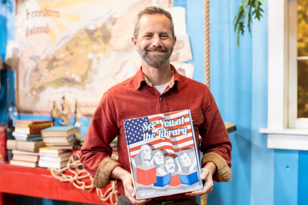 Kirk Cameron holding Brave Books story hour host kit