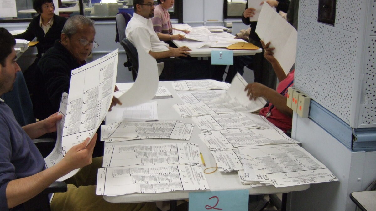 Man sorting ballots