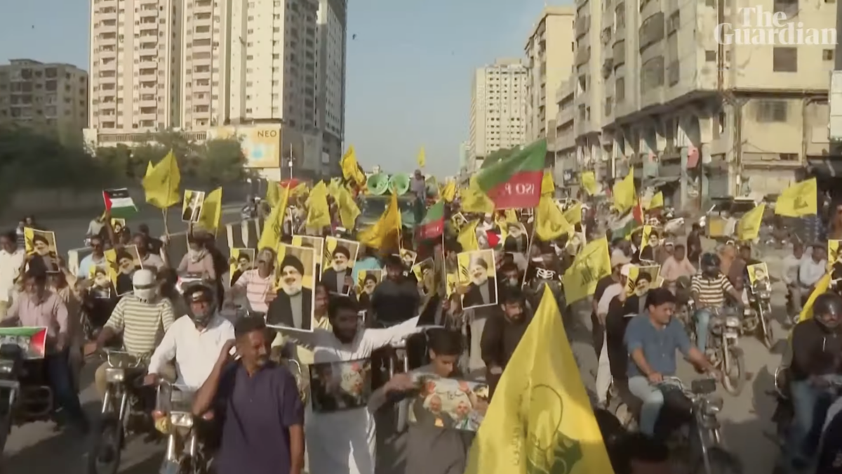 people marching in Pakistan after Hezbollah leader's assassination