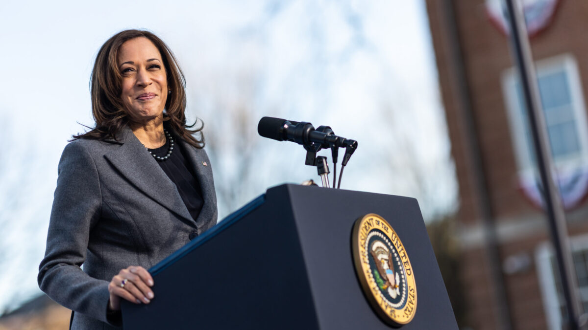 Kamala Harris smiles behind a podium