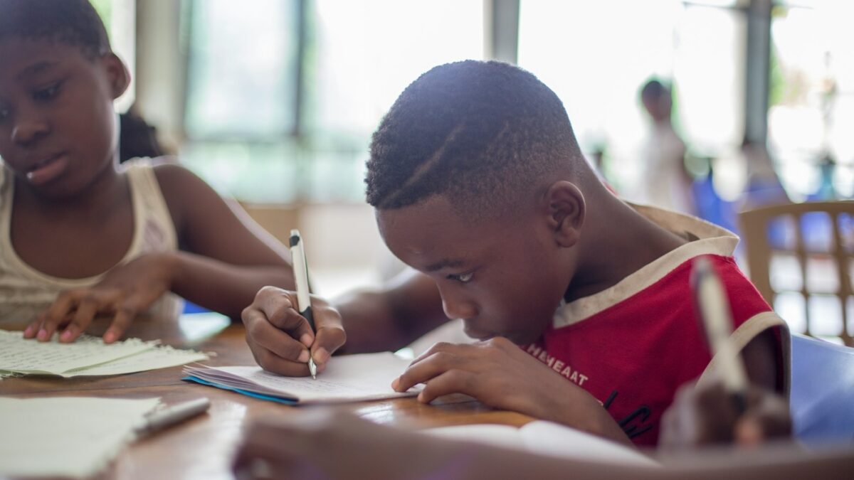 boy works on his homework at a table