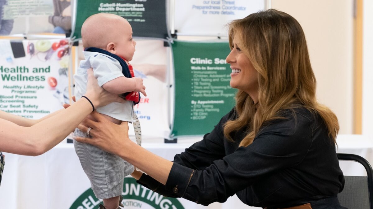 Melania Trump reaches for baby