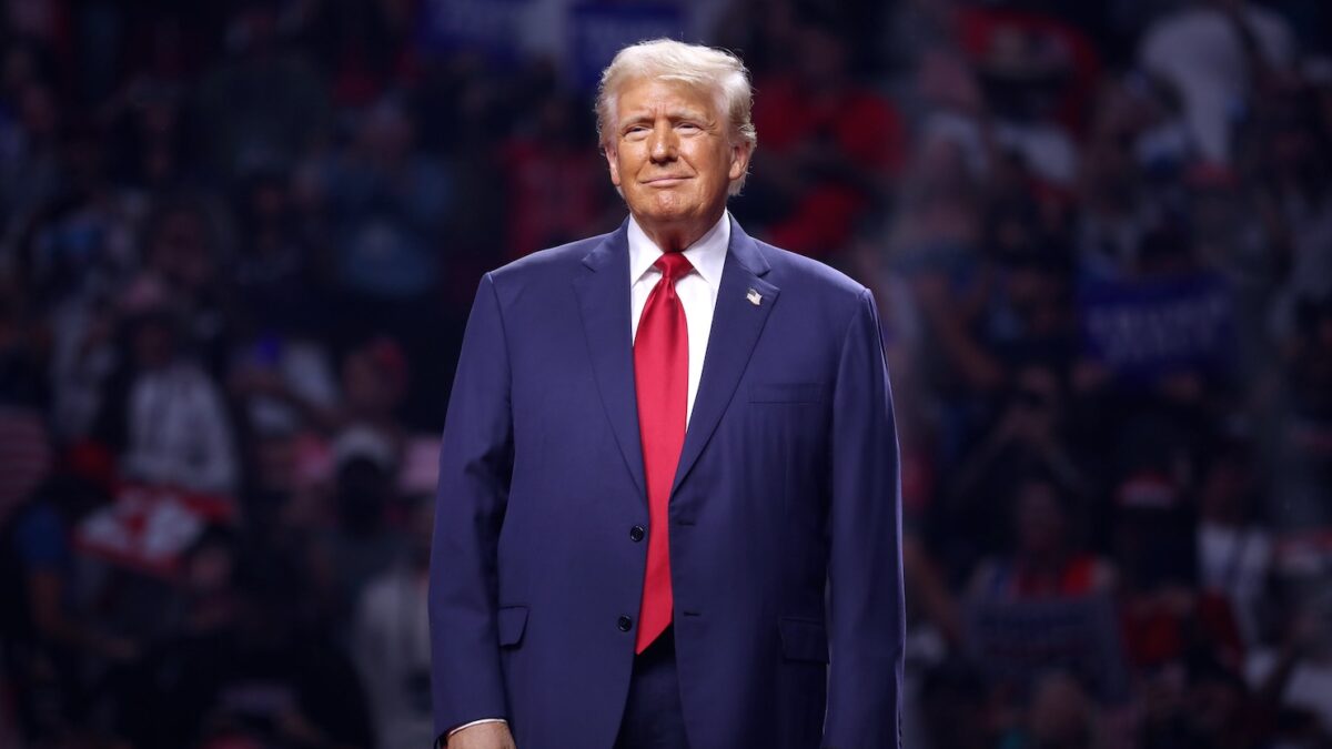 Donald Trump stands on stage at a rally